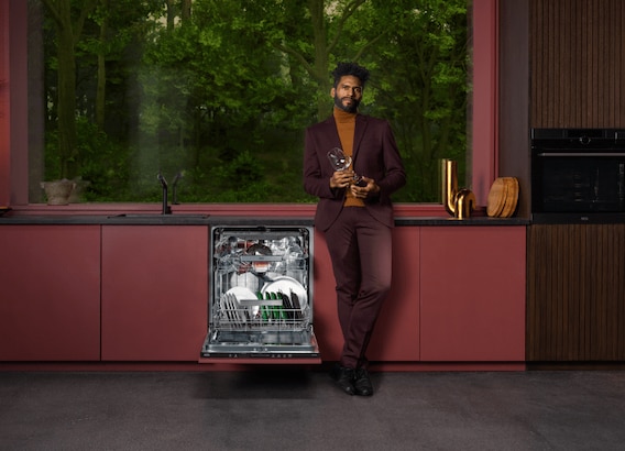 Man standing next to dishwasher